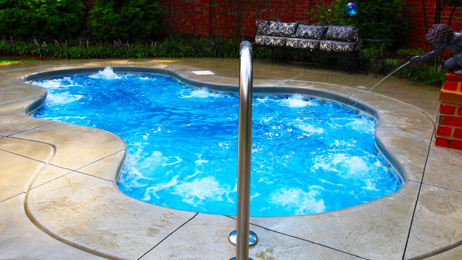 Free-form spa design featuring glowing LED lights at night