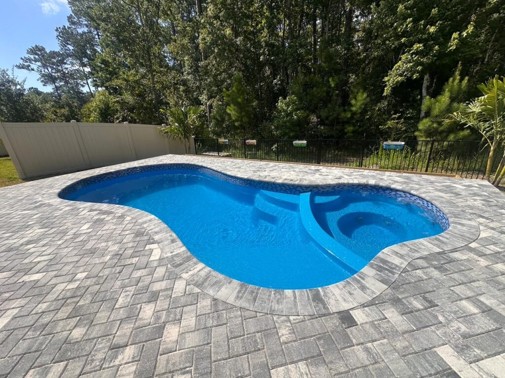 Mandalay Bay pool showcasing dual entry steps and seamless spa, Installed by Pelican Pools with fast installation for family use
