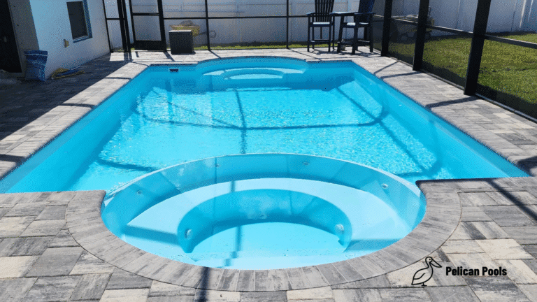 Beautiful Caesar’s Palace fiberglass pool installed by Pelican Pools featuring a Grecian design with curved ends and a built-in spa for relaxation.
