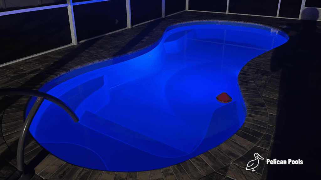 Modern Cocoa Beach fiberglass swimming pool installed by Pelican Pools with fast installation, designed with a freeform shape, built-in steps, and a stylish outdoor look.