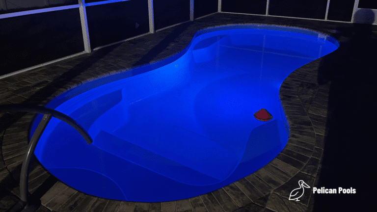 Modern Cocoa Beach fiberglass swimming pool installed by Pelican Pools with fast installation, designed with a freeform shape, built-in steps, and a stylish outdoor look.