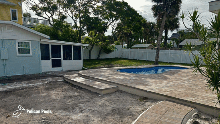 Cocoa Beach fiberglass swimming pool installed by Pelican Pools in Volusia County with a custom paver deck.