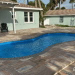 Cocoa Beach freeform pool with curved sport design, installed by Pelican Pools in Volusia County with a custom paver deck.