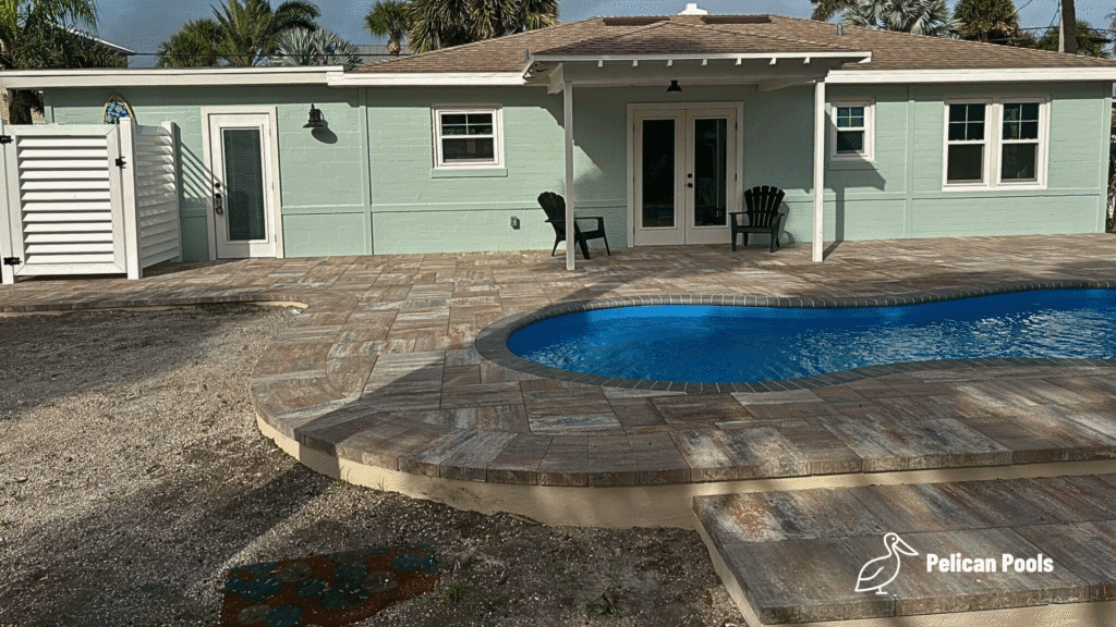 Cocoa Beach modern backyard pool installed by Pelican Pools in Volusia County with a custom paver deck.