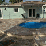 Cocoa Beach modern backyard pool installed by Pelican Pools in Volusia County with a custom paver deck.