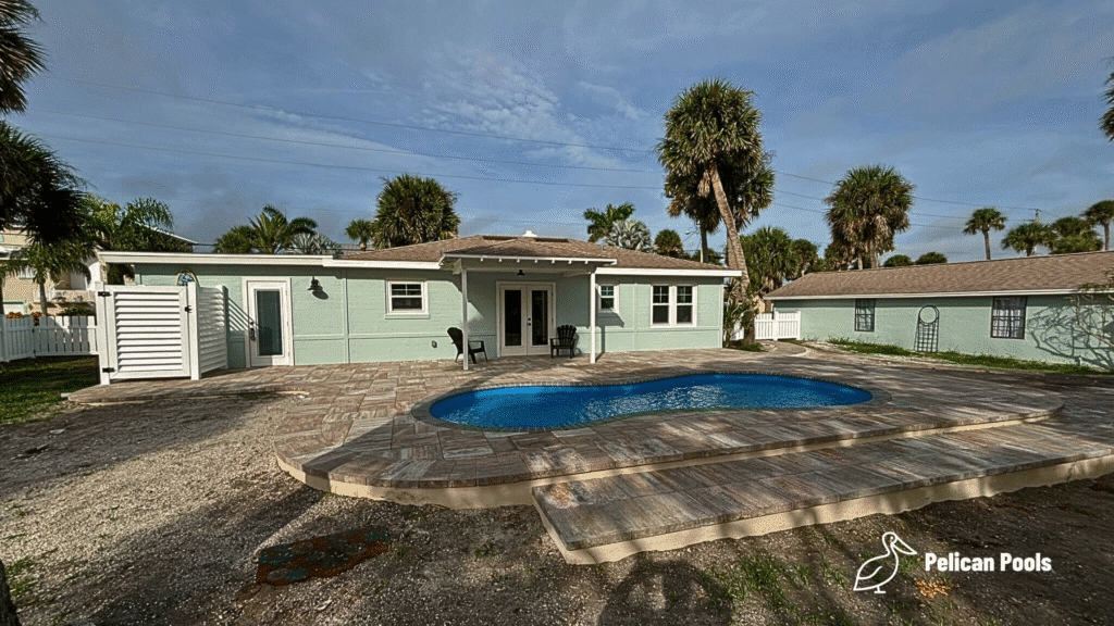 Cocoa Beach fiberglass pool with 5,273-gallon water capacity, installed by Pelican Pools in Volusia County with a custom paver deck.