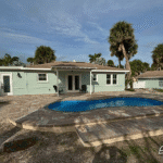 Cocoa Beach fiberglass pool with 5,273-gallon water capacity, installed by Pelican Pools in Volusia County with a custom paver deck.