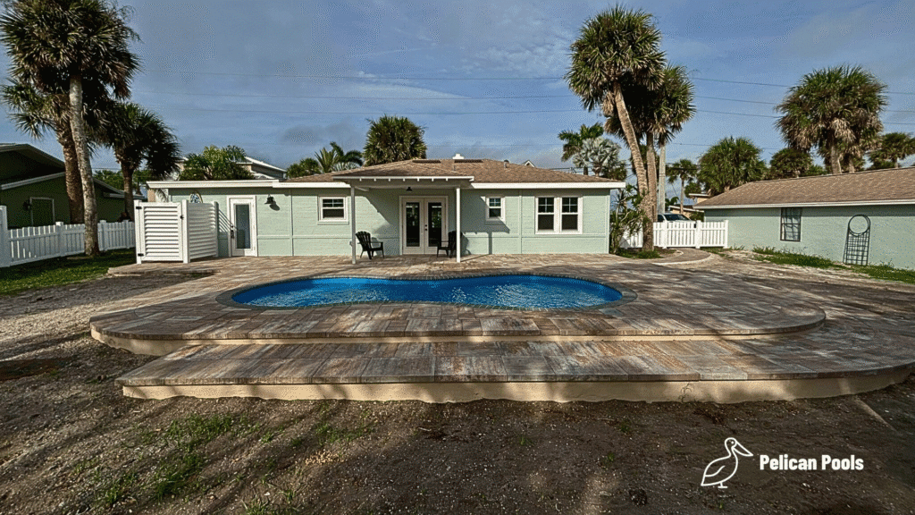 San Juan Pools Cocoa Beach model installed outdoors by Pelican Pools in Volusia County with a custom paver deck.