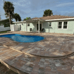 Cocoa Beach compact fiberglass swimming pool for medium-sized yards, installed by Pelican Pools in Volusia County with a custom paver deck.