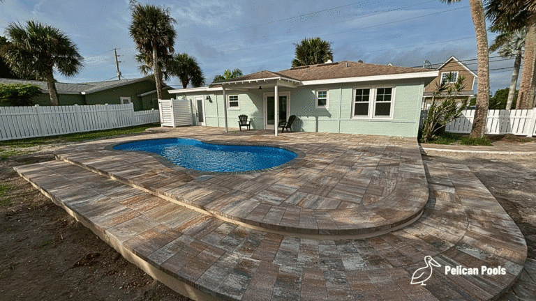 Cocoa Beach compact fiberglass swimming pool for medium-sized yards, installed by Pelican Pools in Volusia County with a custom paver deck.