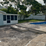 Cocoa Beach Figure-8 fiberglass pool with built-in bench and steps, installed by Pelican Pools in Volusia County with a custom paver deck.