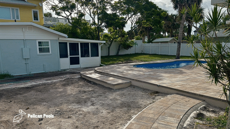 Cocoa Beach Figure-8 fiberglass pool with built-in bench and steps, installed by Pelican Pools in Volusia County with a custom paver deck.