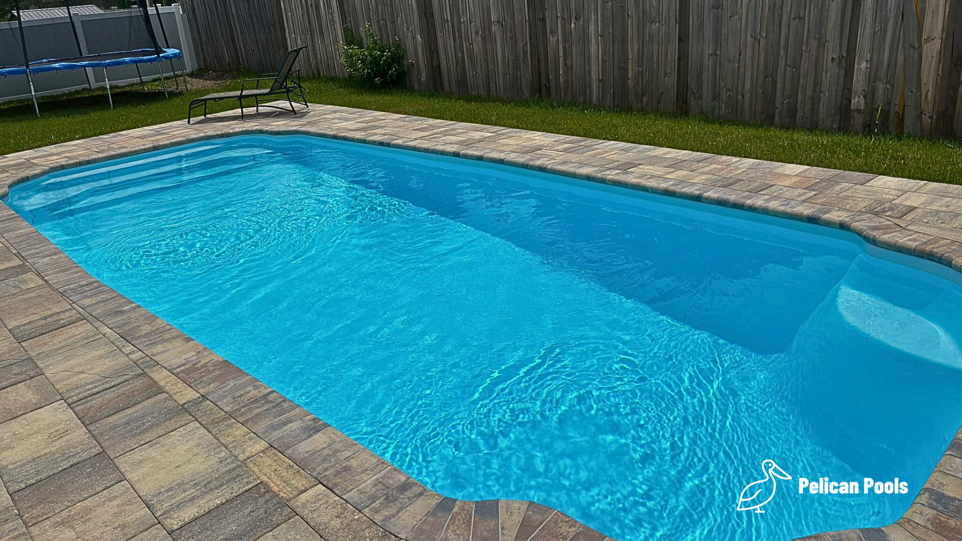 Hawaiian fiberglass pool with Grecian shape and wide shallow entry steps, Installed by Pelican Pools and fast installation, perfect for daily swims.