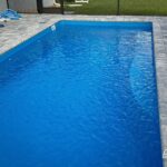 Wylela fiberglass pool installed by Pelican Pools in Palm Coast, Florida with paver deck.