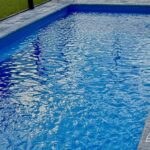 Wylela fiberglass pool installed by Pelican Pools in Palm Coast, Florida with paver deck.