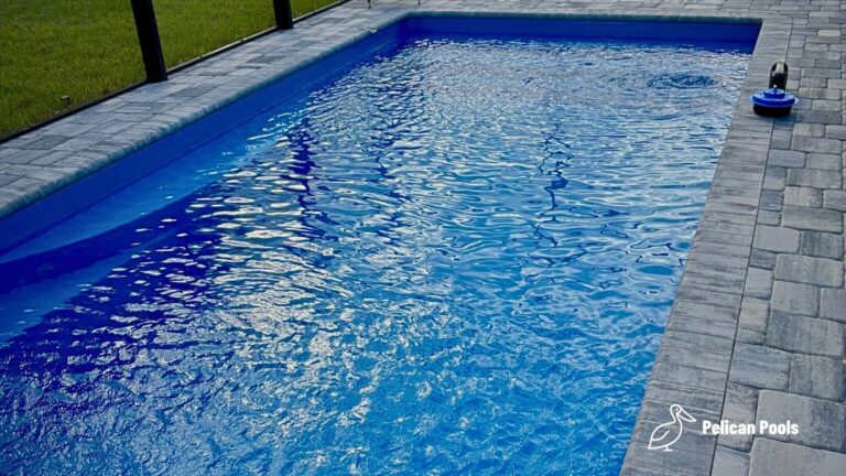 Wylela fiberglass pool installed by Pelican Pools in Palm Coast, Florida with paver deck.