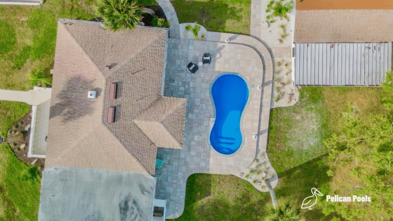 Cocoa Beach fiberglass swimming pool installed by Pelican Pools with fast installation, featuring a figure-8 design, shallow bench seating, and a 5′ 6″ deep end.