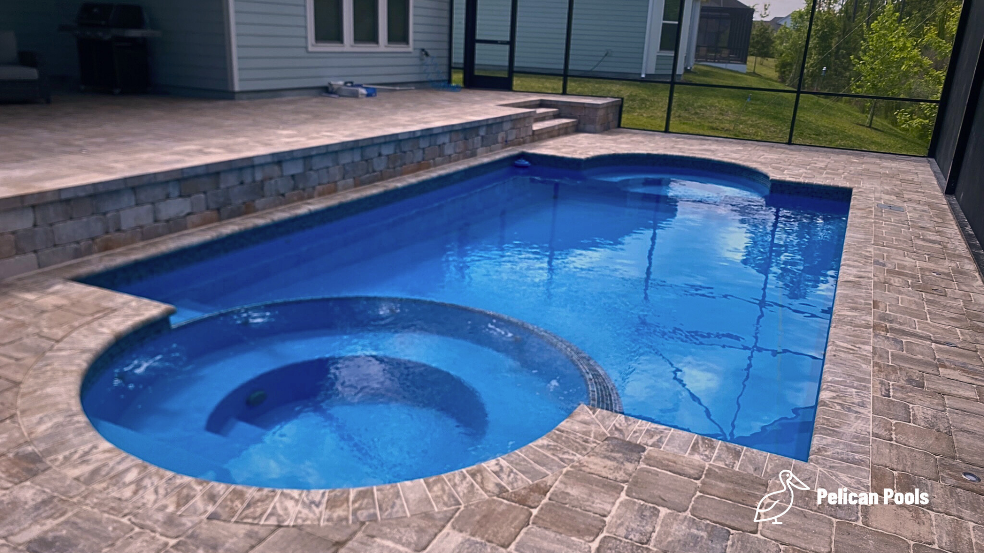 Caesar’s Palace fiberglass pool installed by Pelican Pools with elegant steps, a deep-end lounge area, and fast installation for quick backyard transformation.