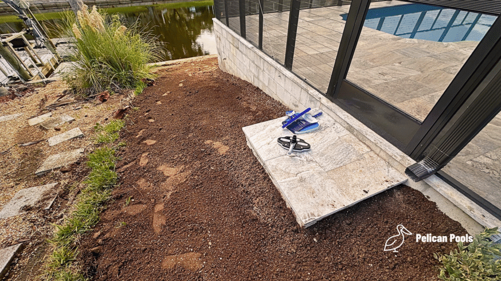 Travertine step outside pool enclosure with yard graded and prepped.