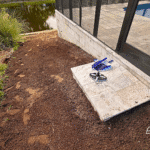 Travertine step outside pool enclosure with yard graded and prepped.