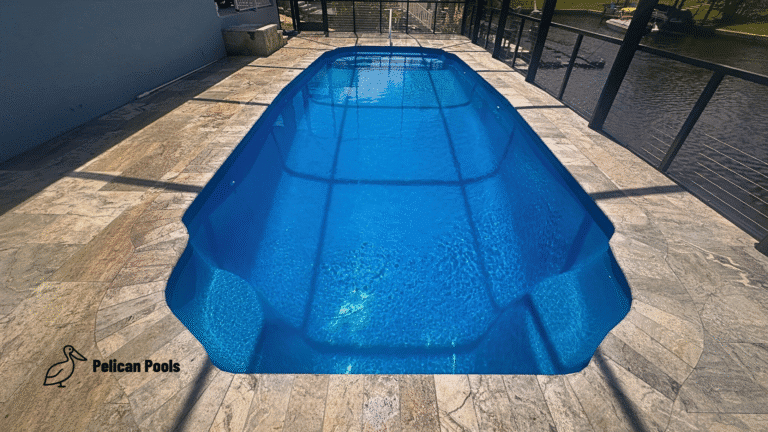 Center view of Hawaiian fiberglass pool with sparkling water under screened enclosure.