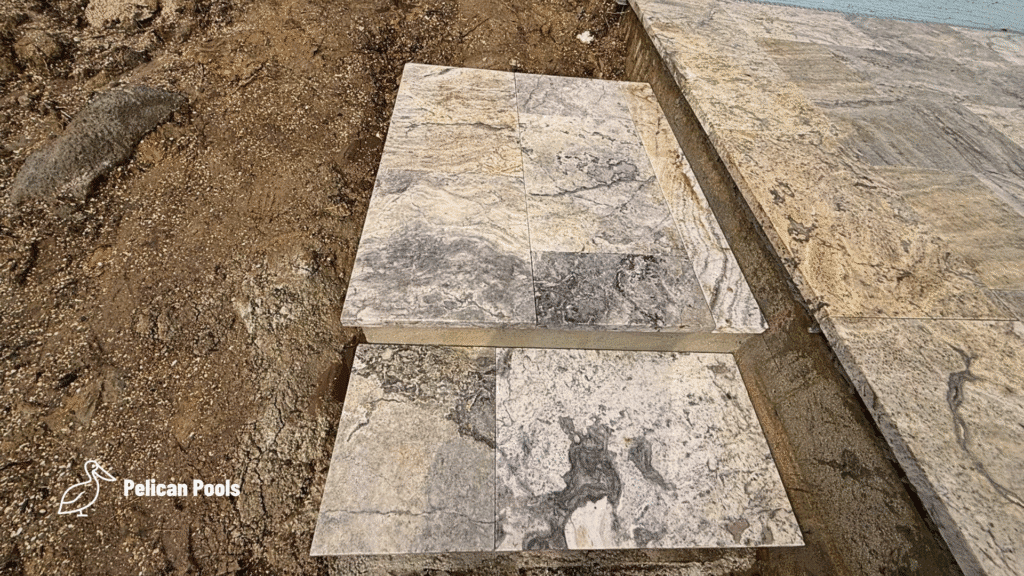 Travertine stone steps leading from deck to yard.