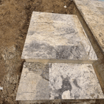 Travertine stone steps leading from deck to yard.