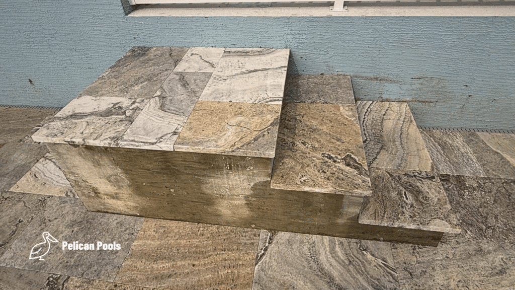 Travertine steps from lanai to pool deck.
