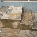 Travertine steps from lanai to pool deck.