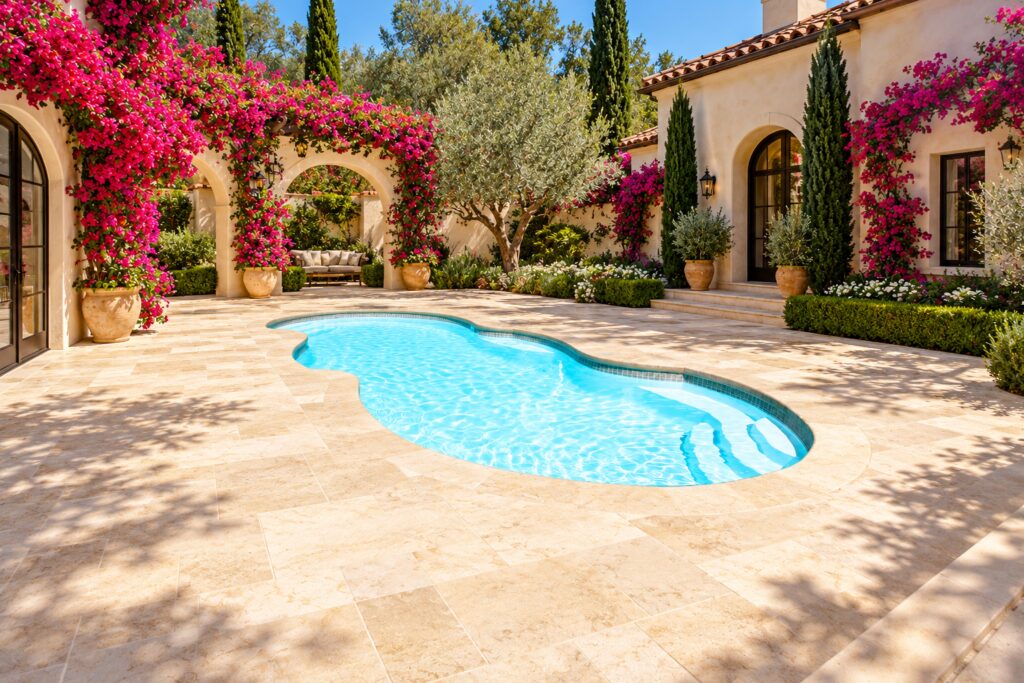San Juan Mirage pool with molded entry steps, cream limestone paving and a bougainvillea courtyard