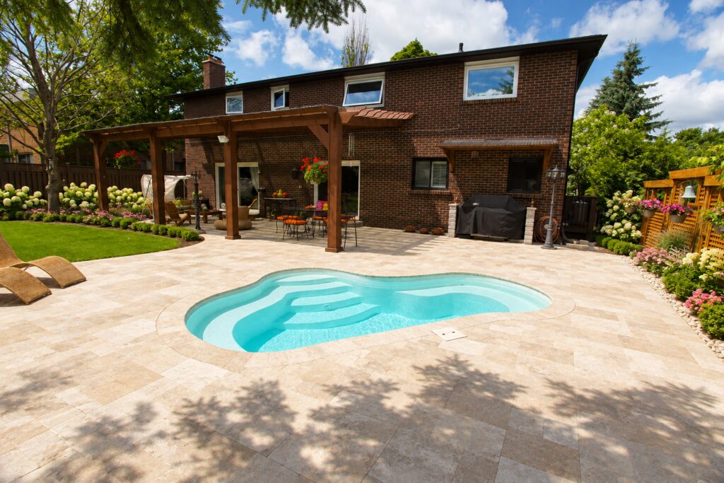 Crystal Springs pool with curved entry steps and a light stone courtyard. Digitally edited design inspiration.