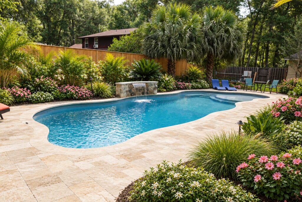 San Juan Daytona Beach Pool – Subtropical Travertine Design Inspiration Daytona Beach pool with a sheet waterfall and flowering subtropical garden. Digitally edited design inspiration.